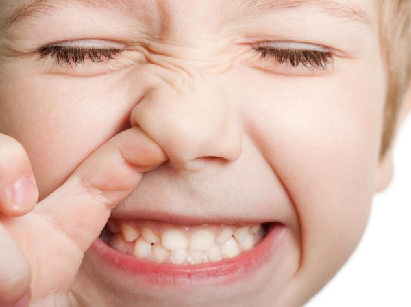 Close-eyed kid picking nose with his mouth open